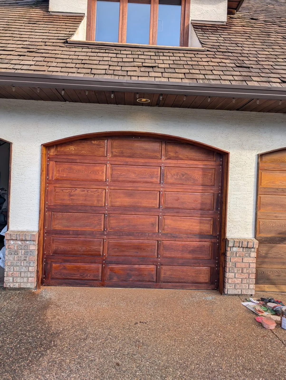 Same garage doors after our team restored them to a rich, sealed cedar finish
