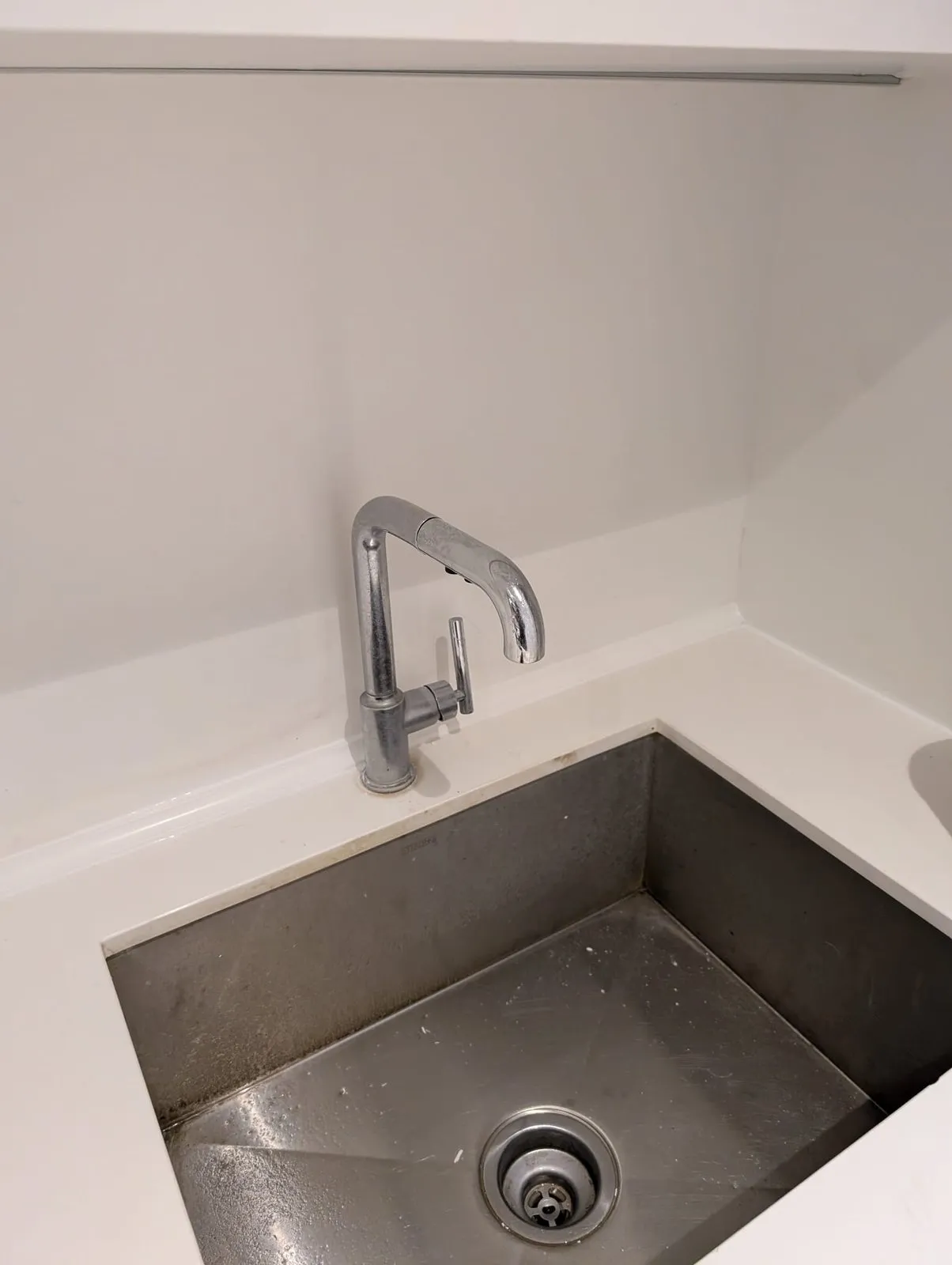 Repaired counter edge and clean sink surround after our team rebuilt the damaged section
