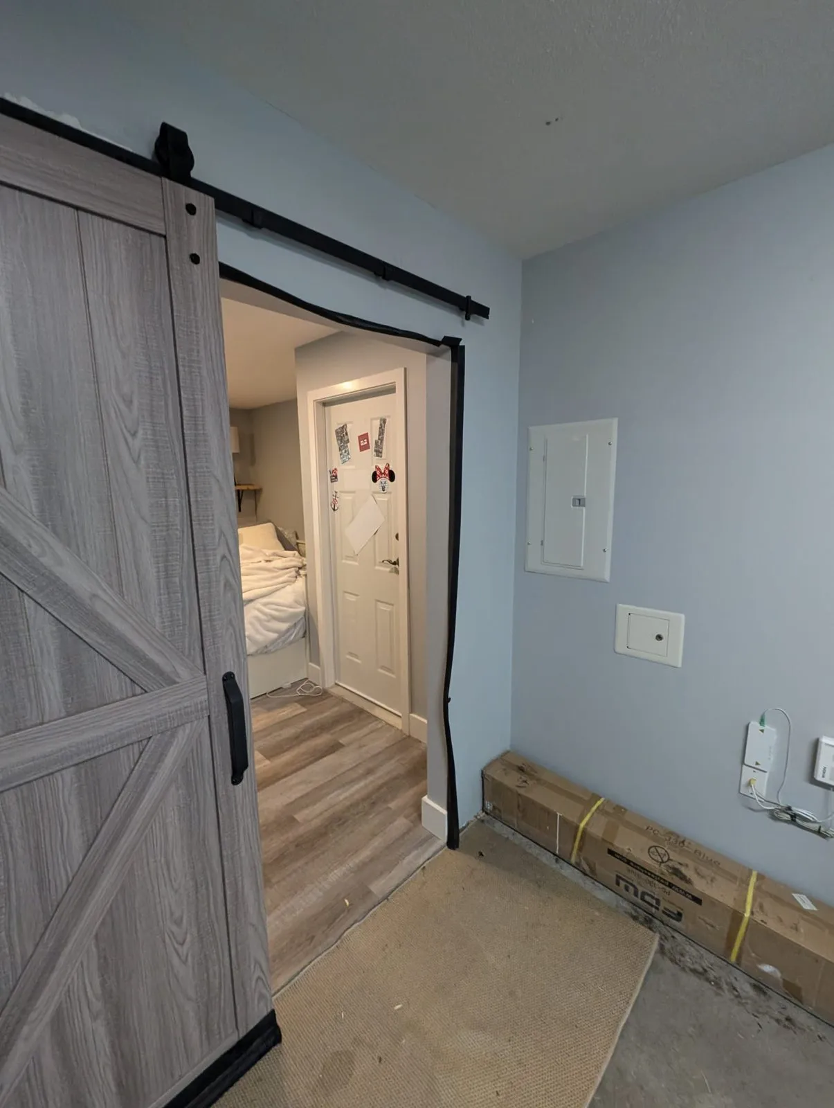 Flex room with a new sliding barn door and the garage opening prepped for a door install