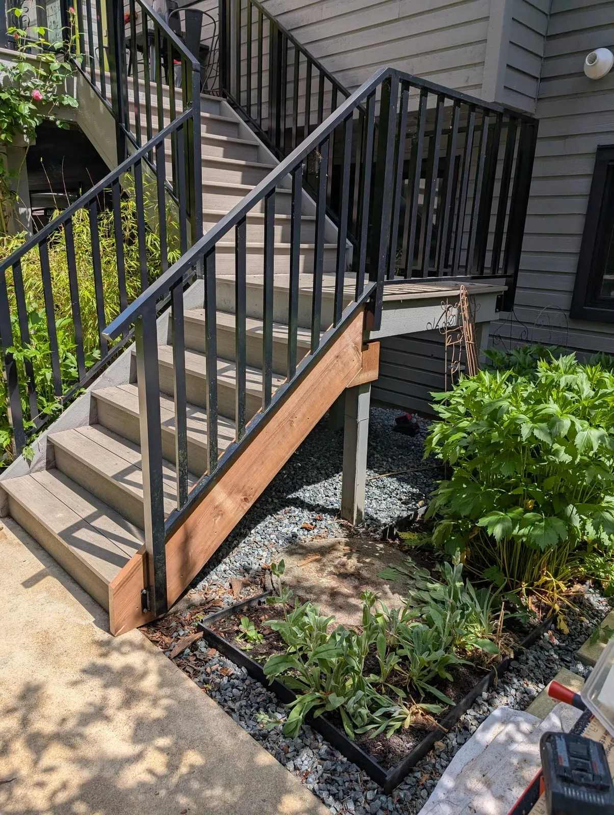 Same deck stairs after our team fitted a new cedar stringer and skirt board and refitted the railing