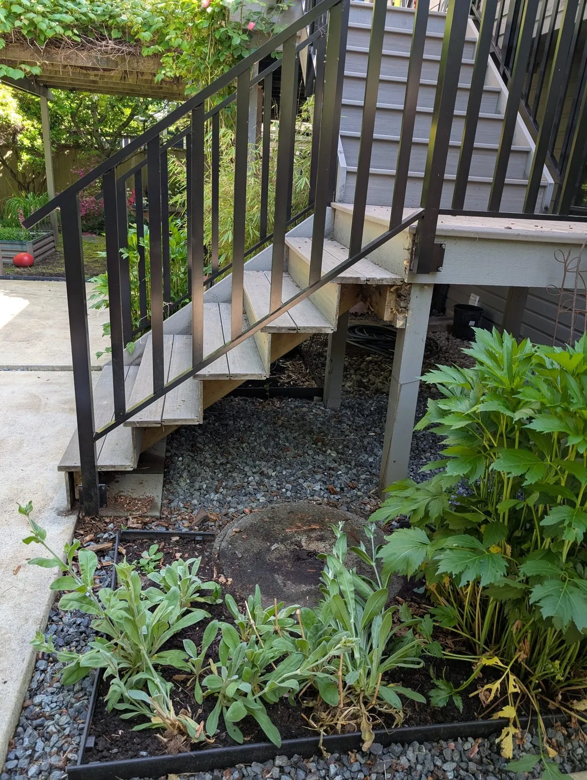 Deck stairs with a rotted outer stringer and worn skirt board before repair in Metro Vancouver