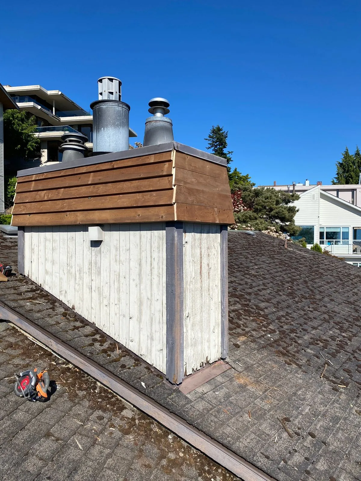 Same chimney chase after our team fitted new stained cedar siding and fresh base flashing